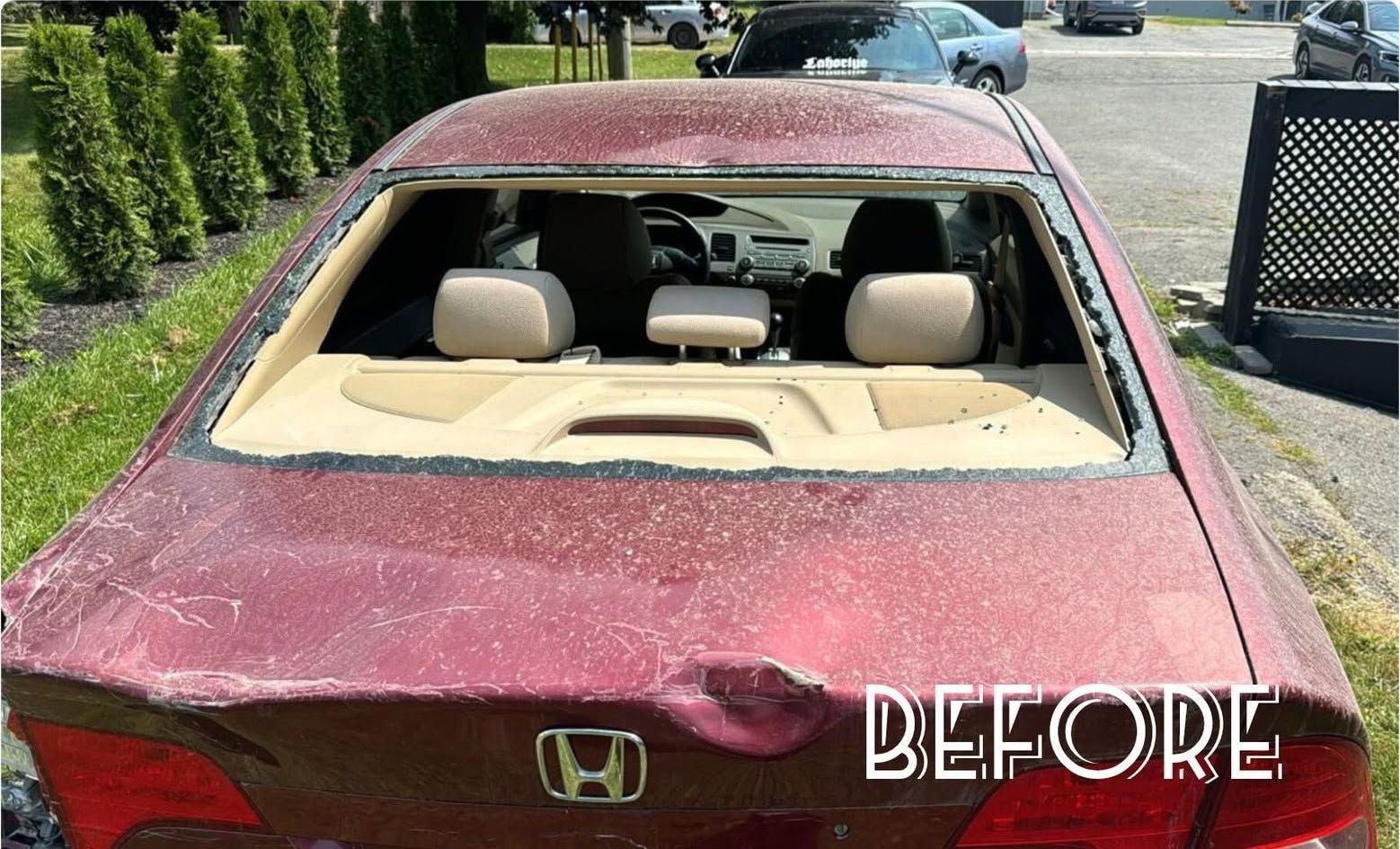 Honda Civic with shattered rear window and dented trunk lid