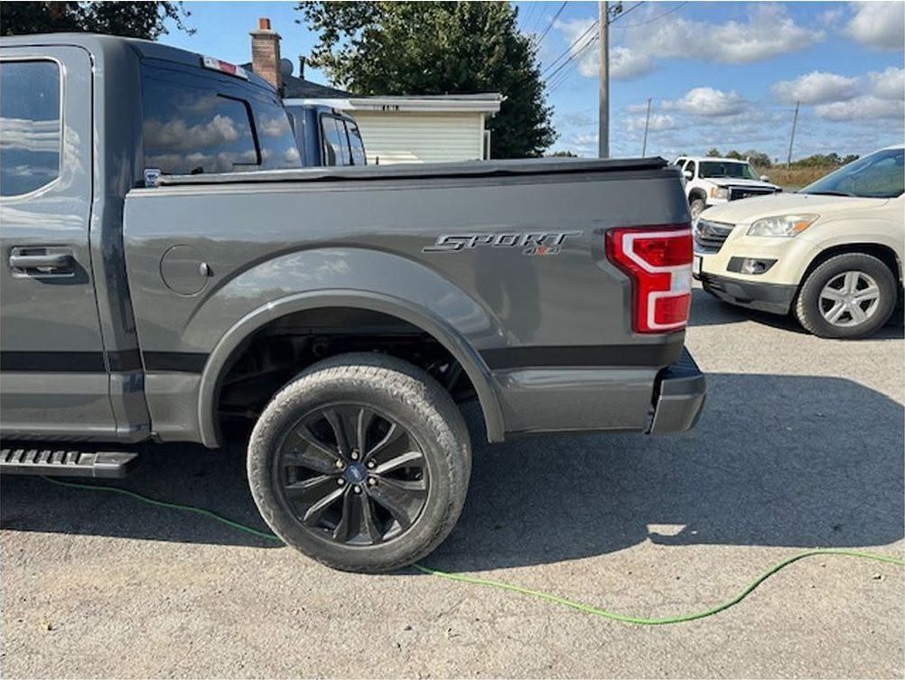 The same Ford F-150 with the bedside repaired and repainted